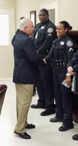 Pictured: Cpl. Kimber Gist, shot Friday morning, shakes hands recently with Sheriff Duane Lewis. (Via Berkeley County Sheriff's Office)