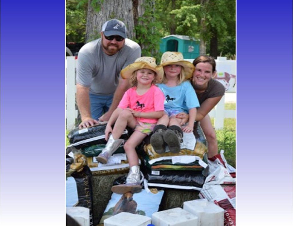 Pictured L to R Brad, Riley, Merritt & Ann-Magill Payne Sitting on a mound of donations collected to include feed, supplements, hay, salt blocks, halters, shampoo/conditioners, fly spray, gift cards & monetary support