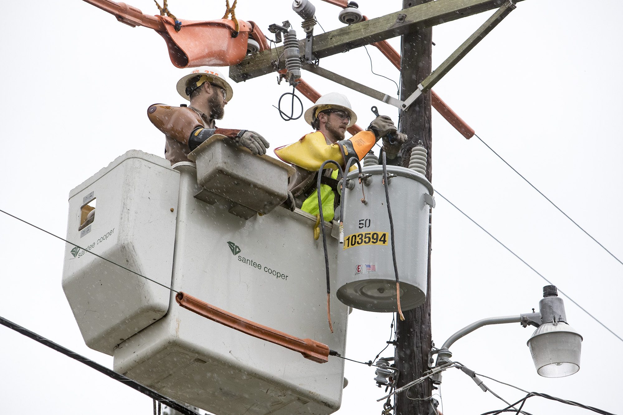 Pictured: Santee Cooper lineworkers replace a transformer in Little River as Hurricane Matthew passes on Saturday.